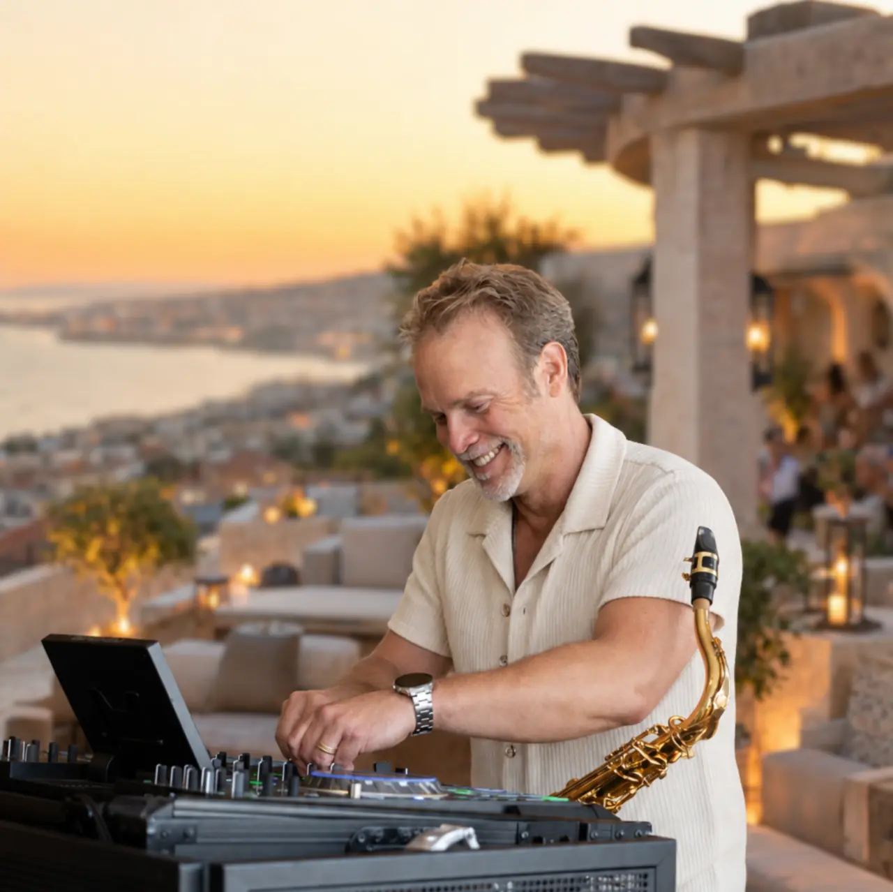 Howard Anderson performing with a DJ controller and saxophone at a sunset event